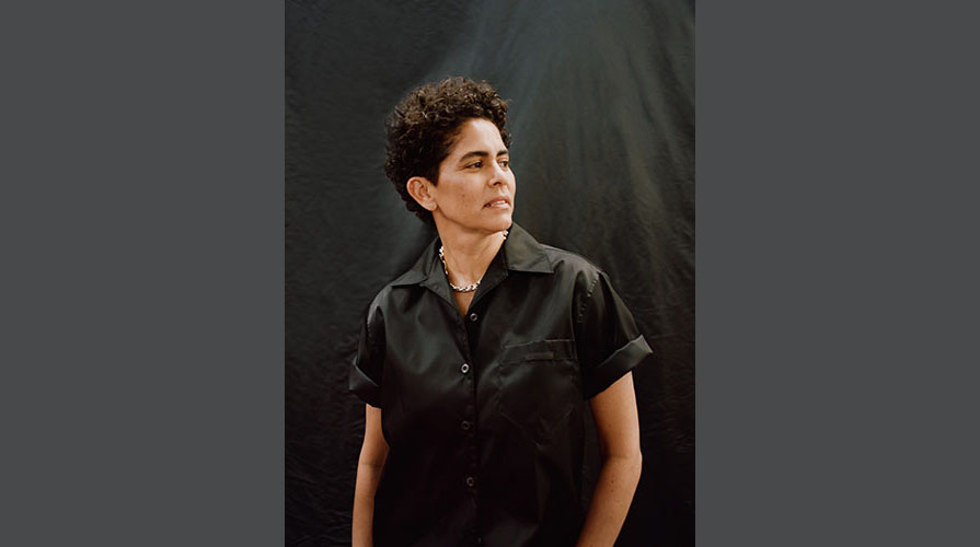 Portrait of Julie Mehretu with a black top in semi-profile