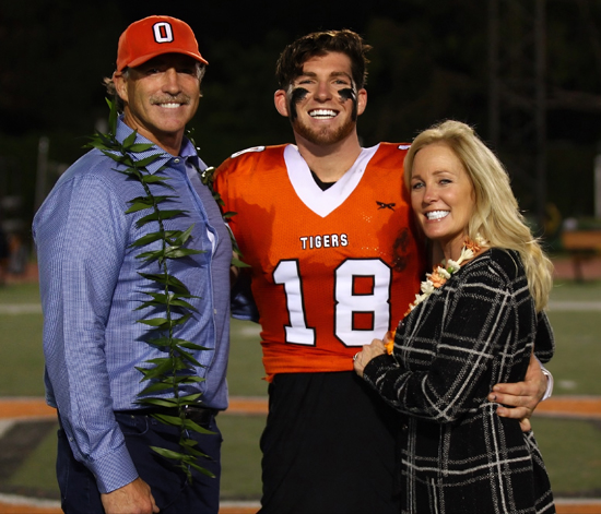 Bryan Scott '17 with his parents, Bob and Leslie Scott, on Senior Night in 2016.