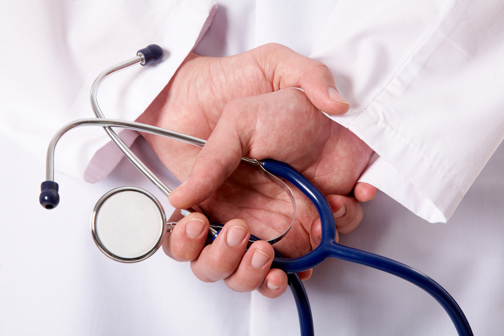 a doctor holding a stethoscope in his hands