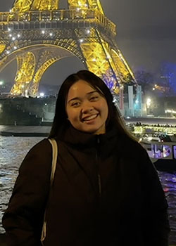 Occidental College computer science major Princess Leus in front of the Eiffel Tower