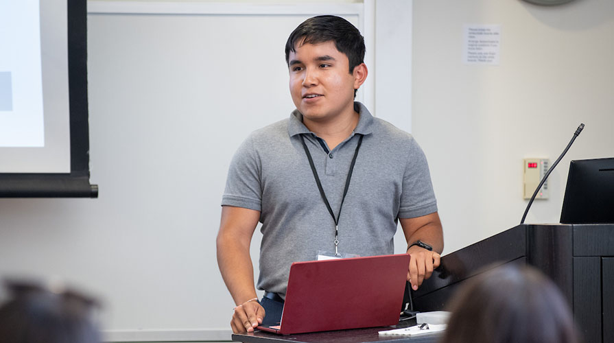 Occidental College student Raymond Arias '26 presenting at the Undergraduate Research Conference on campus