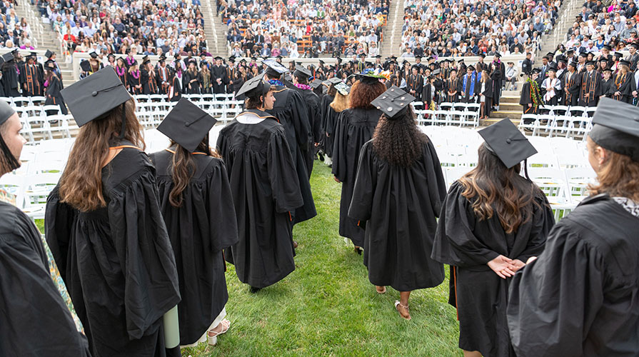 Occidental College graduating seniors in formation in the Greek Bowl, facing away from the camera