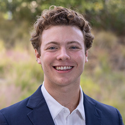 Thomas Quick headshot navy sports coat