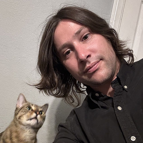 Ty Lyman '27 headshot with his cat