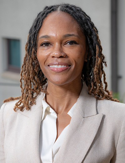 Tiffany Wheatland Disu headshot with beige blazer