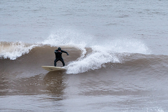 Keala Ede ’00 surfs on Lake Superior in Minnesota.