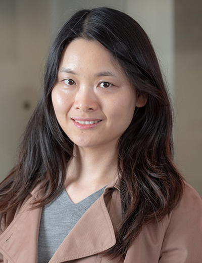 Meiqing Zhang headshot with tan coat