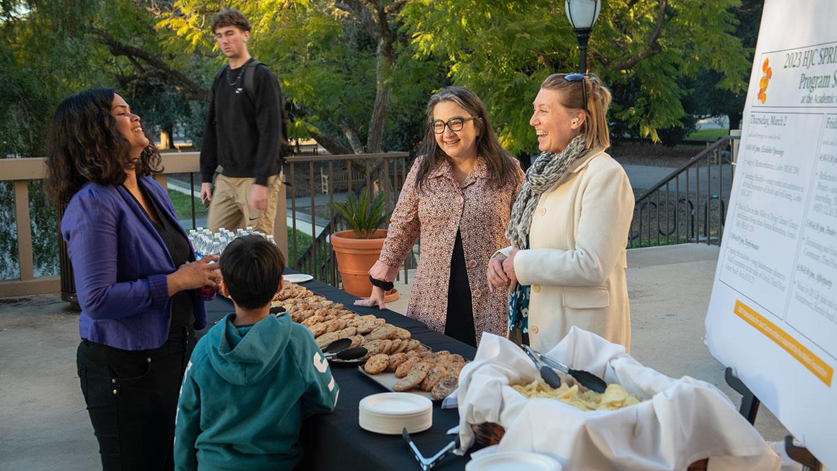 professors and students at a table outside the Oxy library