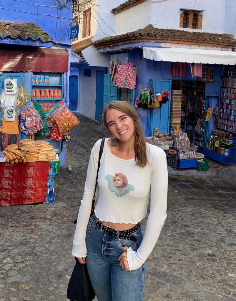 Anna is pictures outdoors in a market square