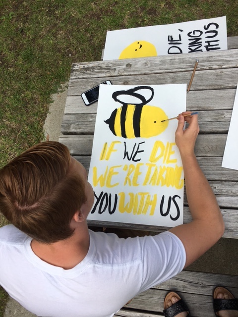Student making additional bee signs