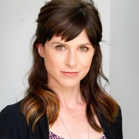 Occidental College Professor Sarah Kozinn headshot with long brown hair