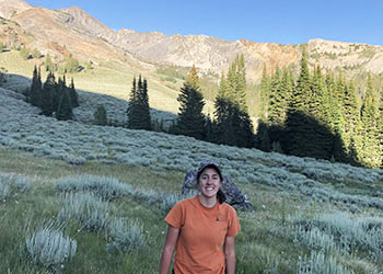 A photo of Occidental college student Fiona Pedrick in a mountain range