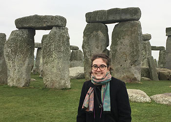 Occidental College student Jackie Dall standing in front of a rock structure 