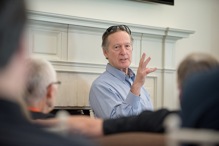 Prof. Dale Wright is speaking to a group and gesturing with his hand