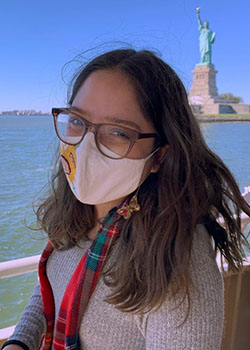A head shot of Occidental college student Andrea Marquez wearing a mask on a boat 