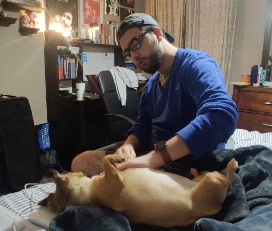 Andrez Parra petting a dog 