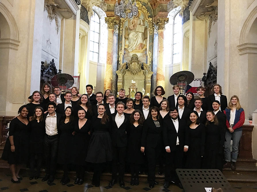 The Glee Club posing inside of a church