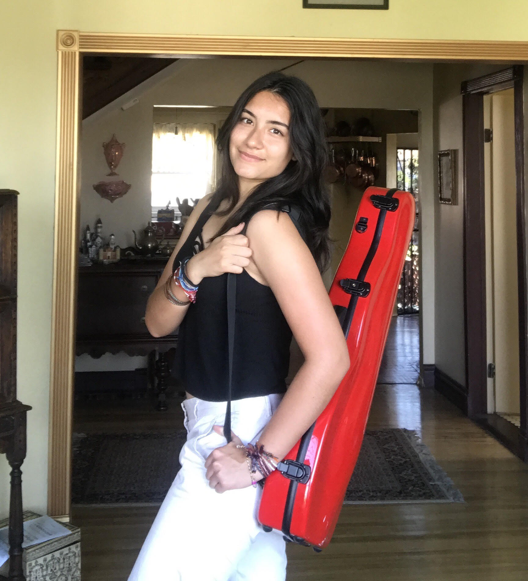 Yoli Patzkowski standing with a guitar strapped to her back