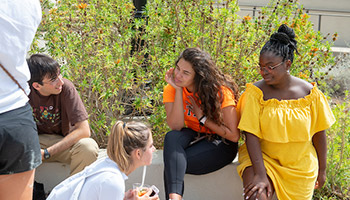 Students sit in a circle chatting