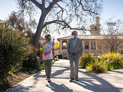 President Harry Elam walking on the Occidental College campus with a student