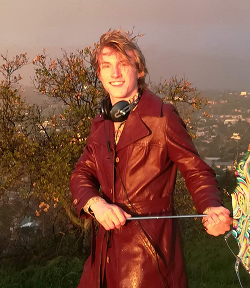 Ian is wearing a dark red leather jacket