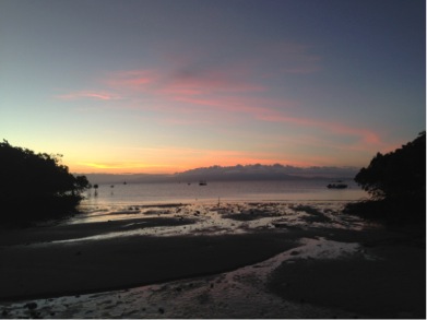 A view of a sandy beach at sunset