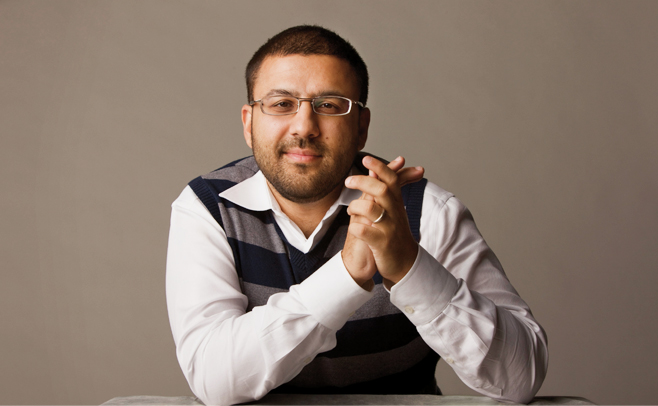 A man looking into the camera with glasses