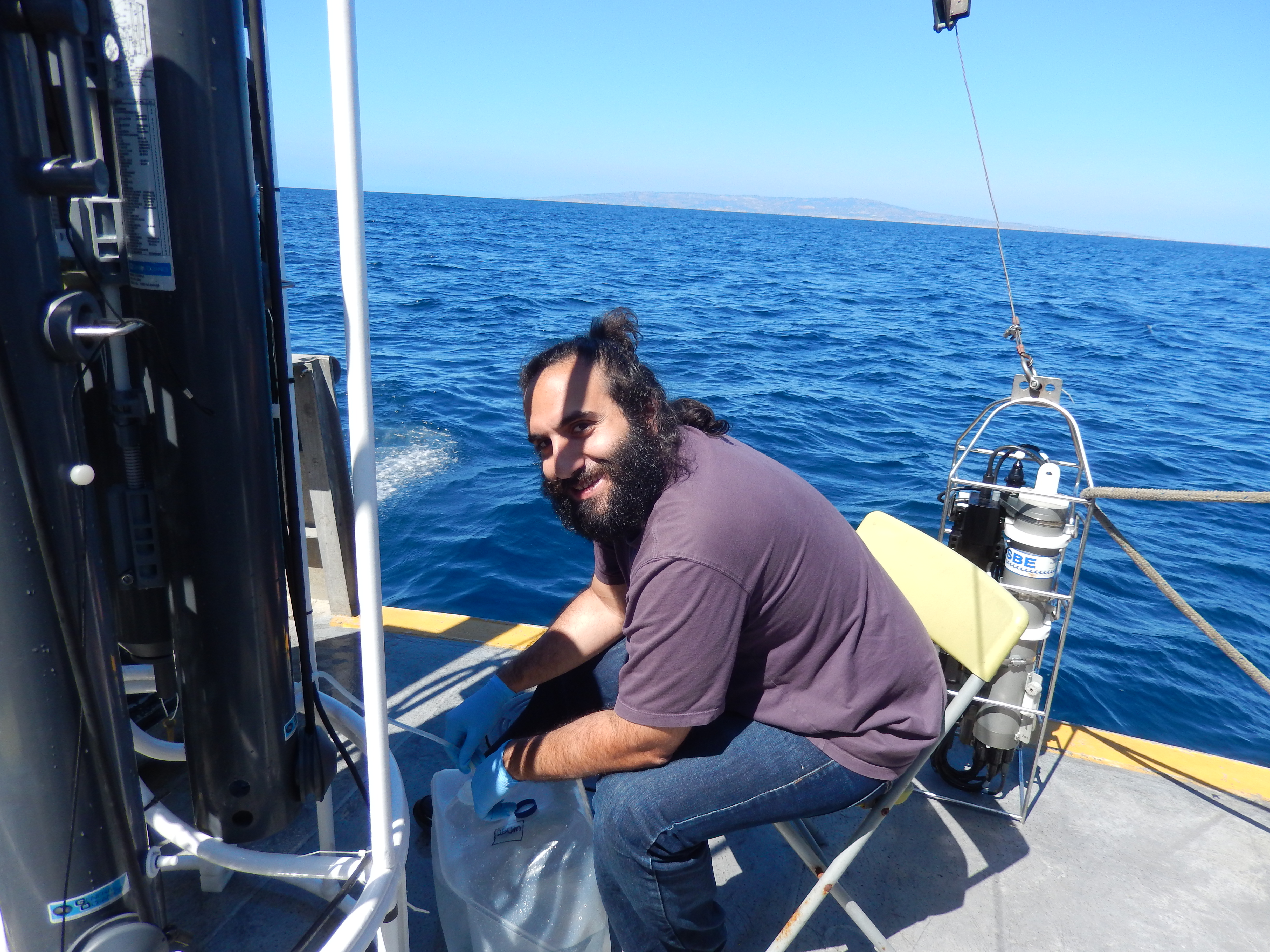 Babak Hassanzadeh doing research with the ocean behind him