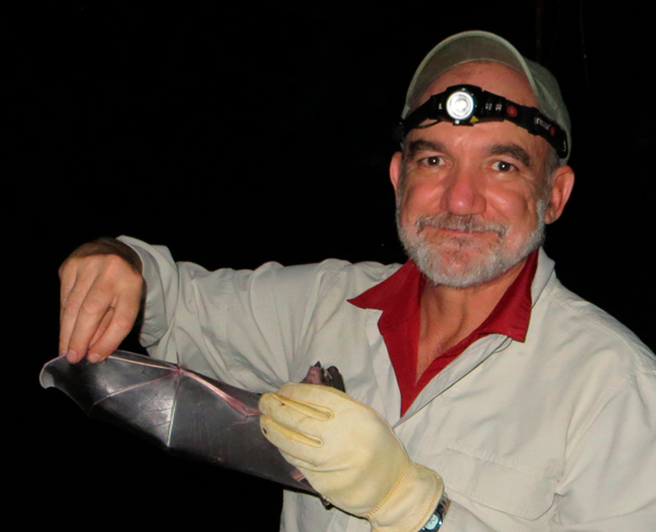 Dr. Rodrigo A. Medellín holding a bat