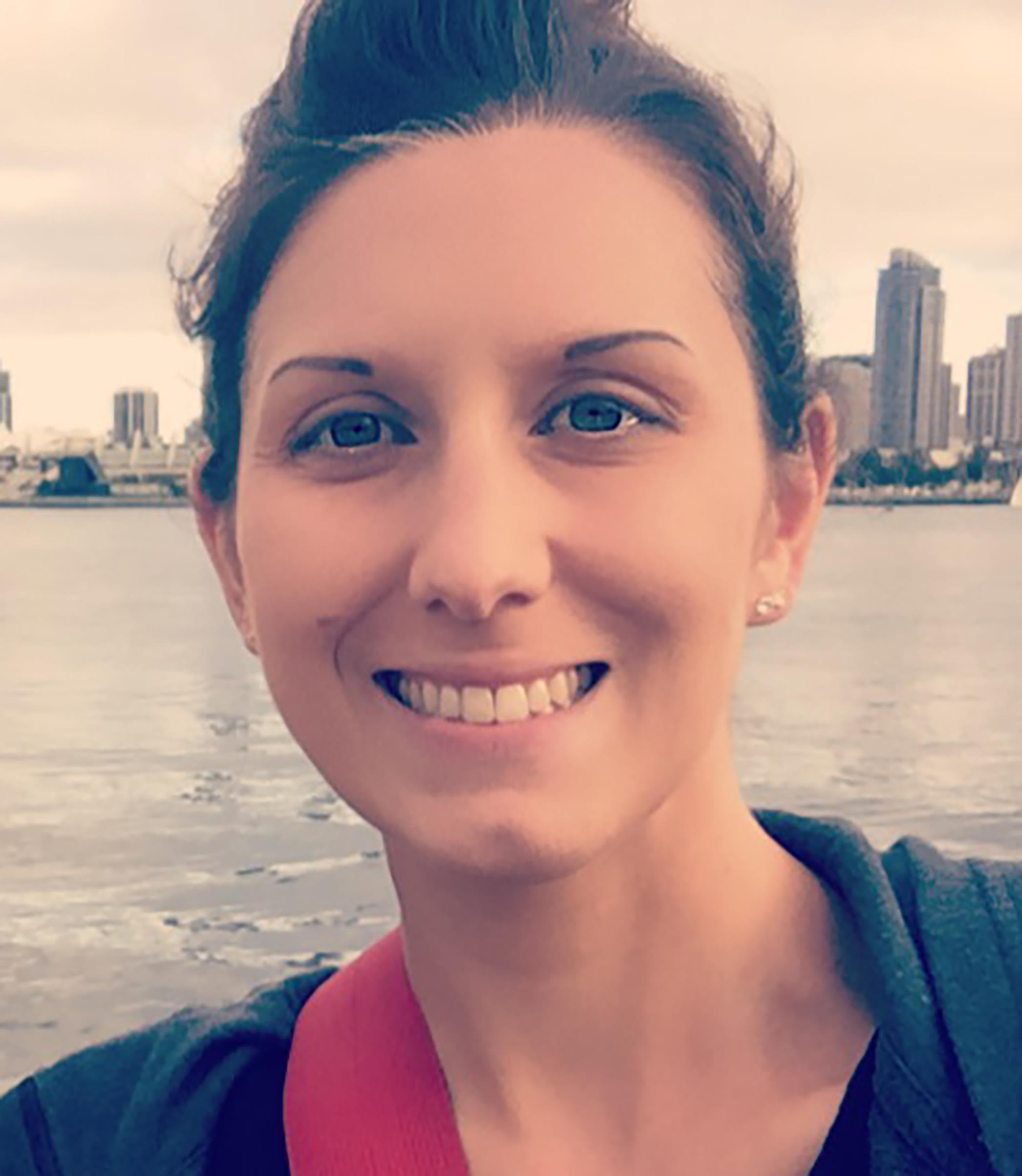 Erica Hutchins smiling in front of city skyline