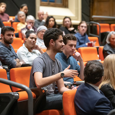 Student of color speaks in audience while others look on