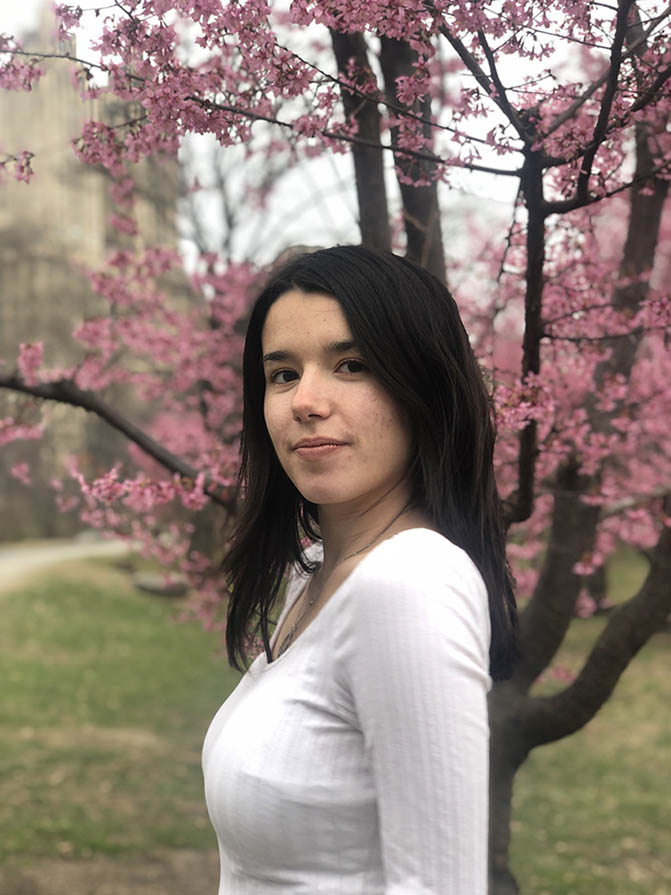 Anna Gray in front of a tree