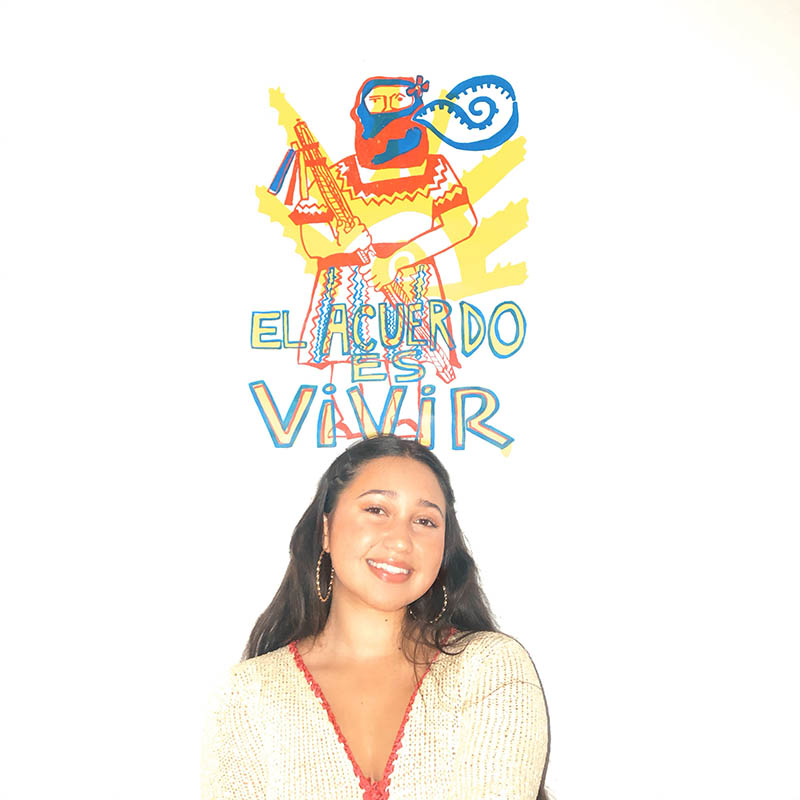 Brenda Jackson in front of "To Remember is to Live" poster