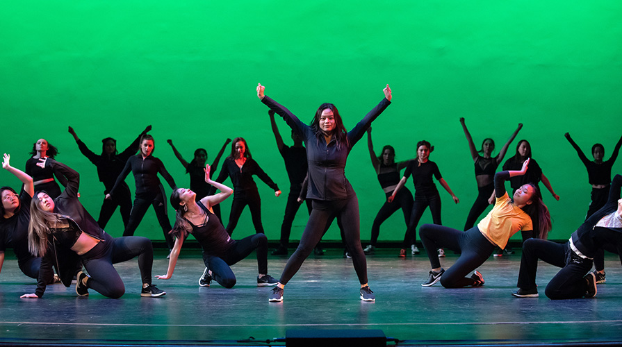 Dance Pro dancers perform in front of green background