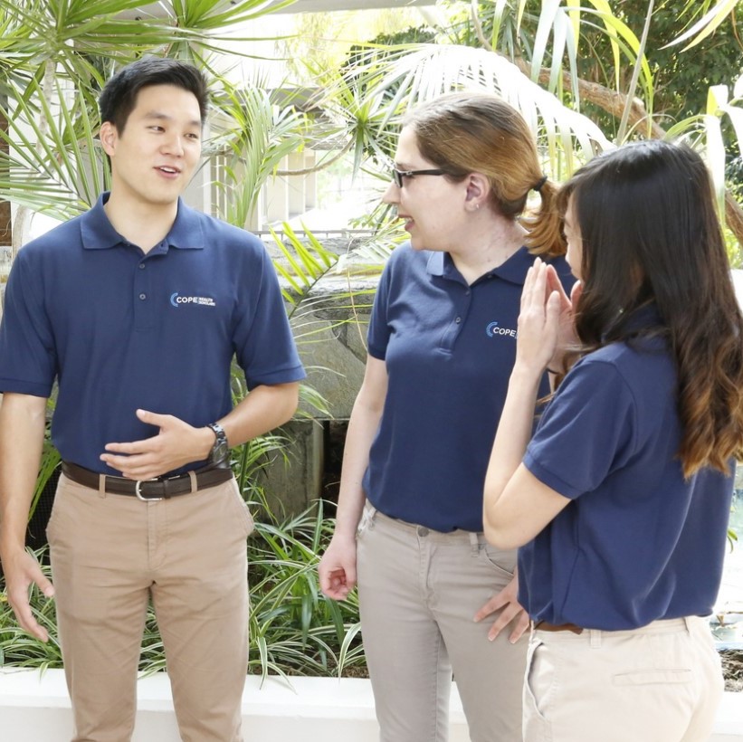 students in COPE Health Schoalrs uniform talking outdoors