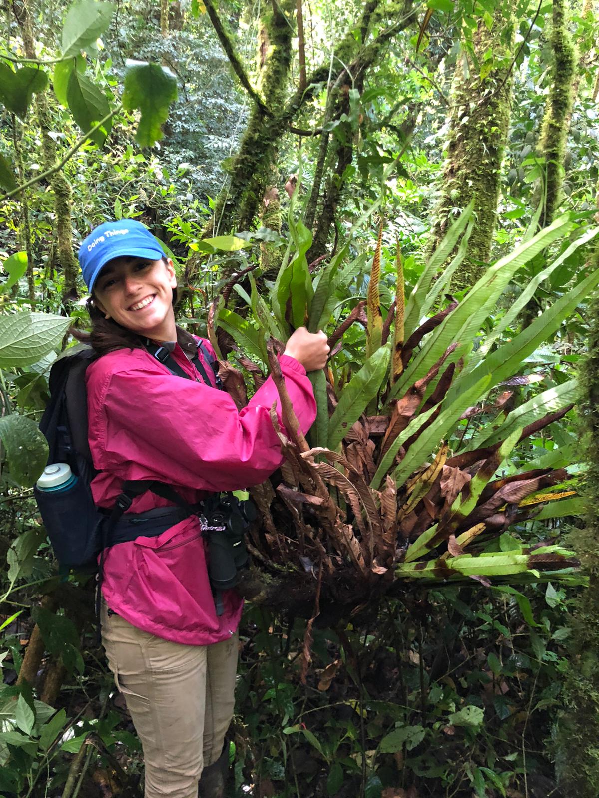 Photo of Lindsay McCulloch in the field in front of plants