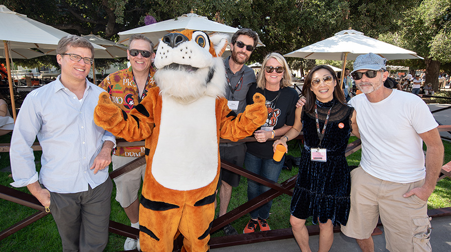 Oxy alumni pose with Oswald, Oxy's Tiger mascot
