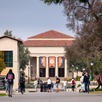 Thorne Hall in the background with students walking to class in the foreground.