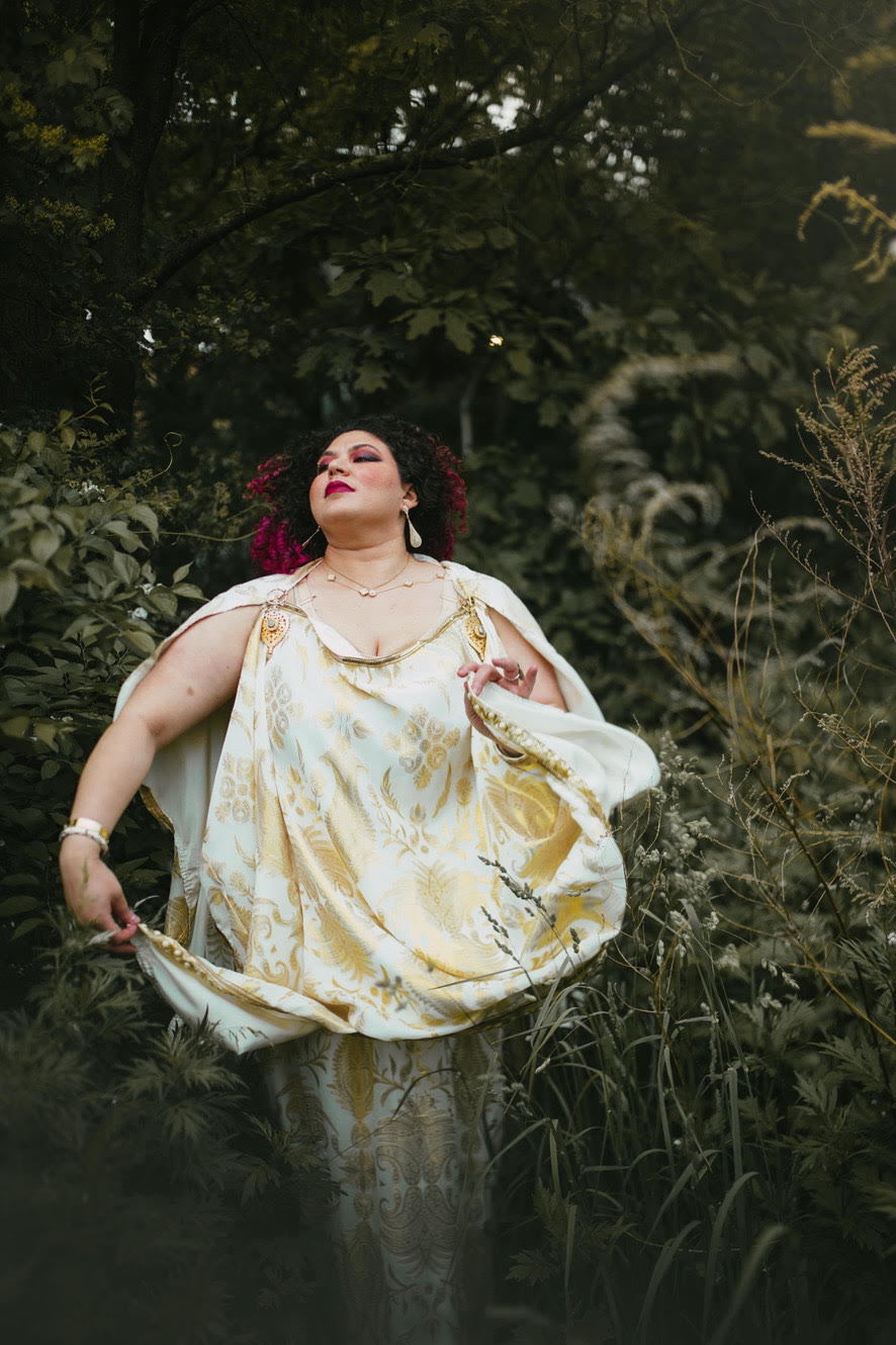 unnamed.jpg Esraa surrounded by trees with her face turned to the side
