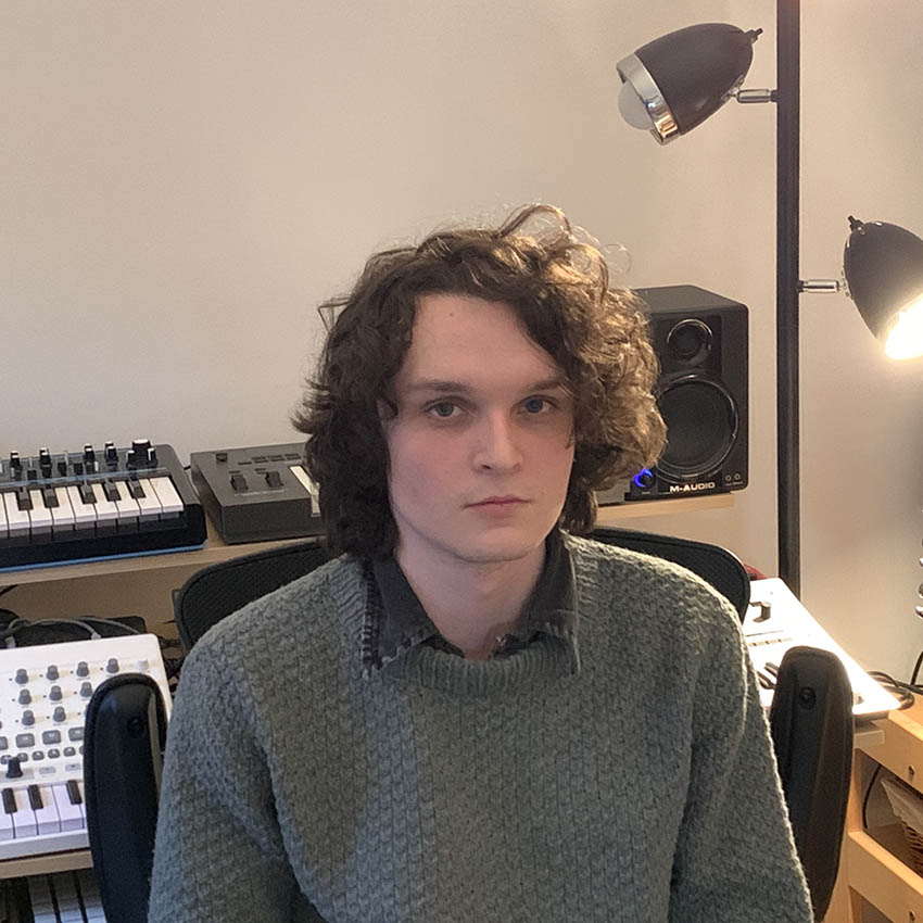 Will Black sitting in front of synthesizers
