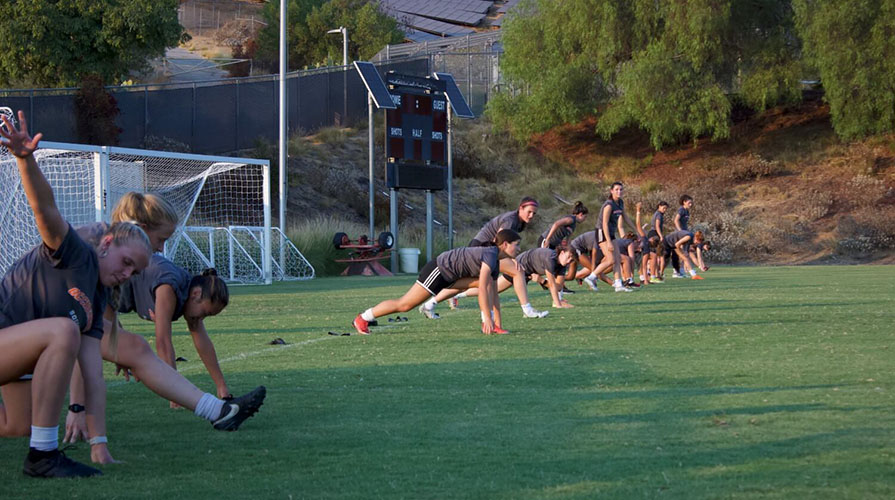 first year students warming up on the soccer field