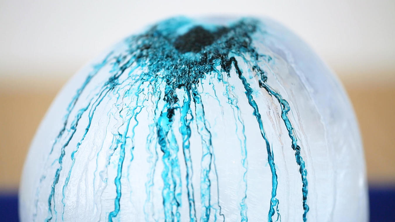 ice_balloons0.jpg Frozen balloon of water with pigment dripping on the top
