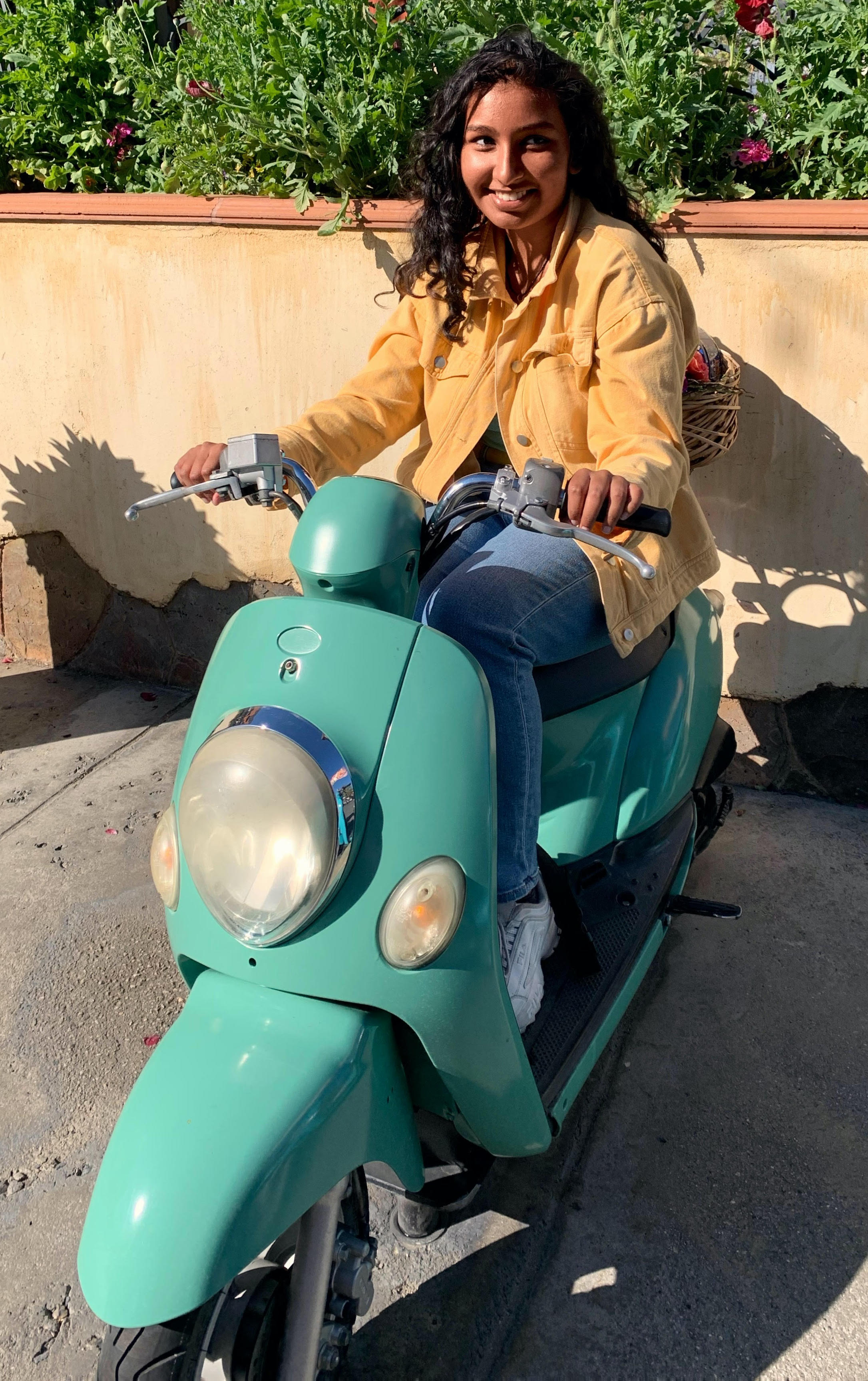 Naya Ramtahal sitting on a motorized scooter