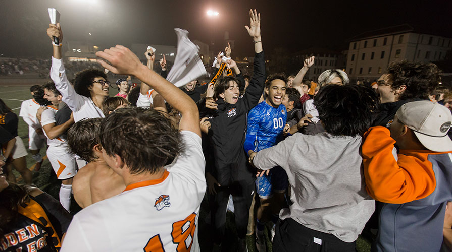 Occidental College men's soccer team members celebrating their SCIAC championship win.