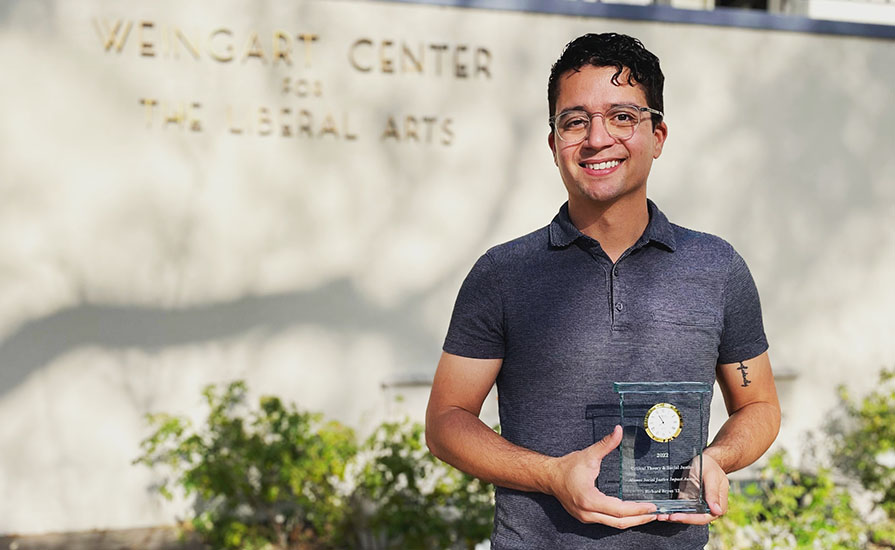 Richard Reyes '12 holds his CTSJ alumni social justice award