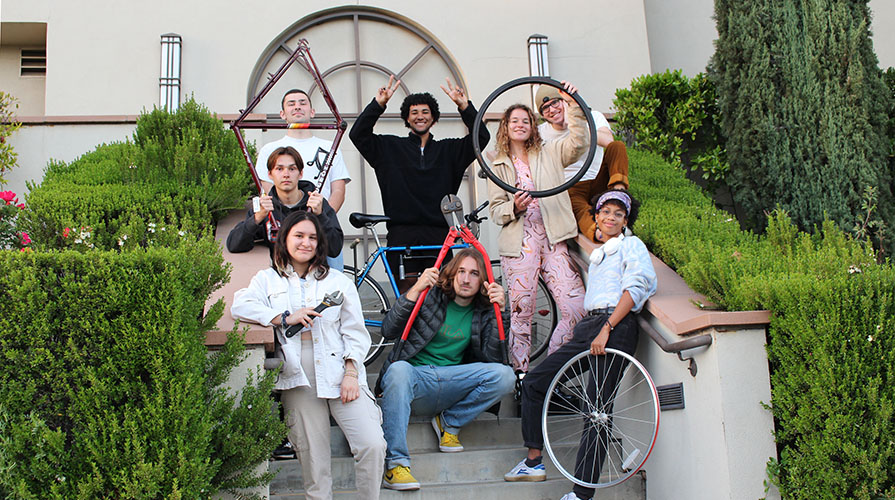 Bike share students posing as a group with bike parts