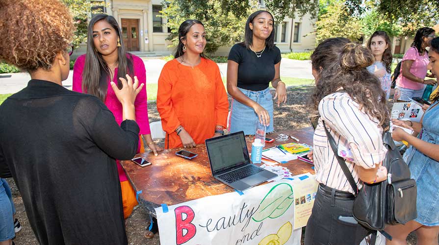 Students at a booth talking to visitors at the Involvement Fair