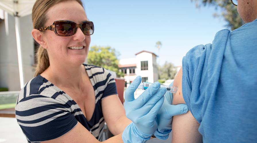 Emmons staff give flu shots to students, staff, and faculty on the quad