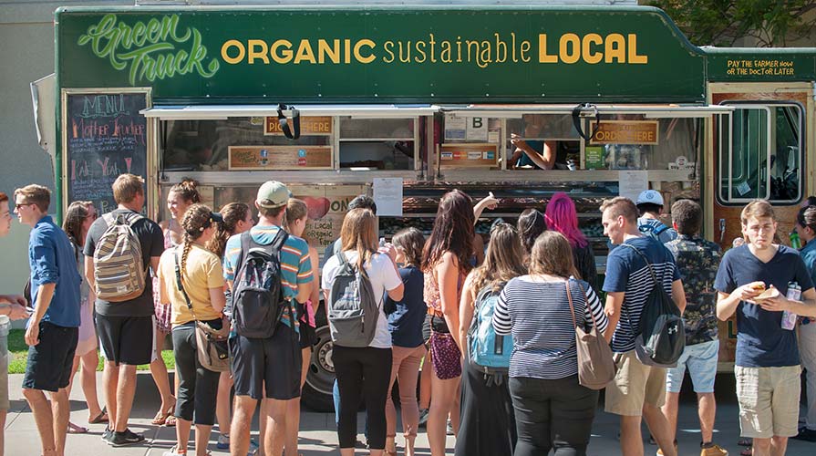 Students wait in line at the Green Truck during a Food Justice Month event