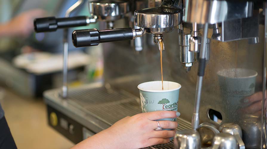 A barista pours an espresso drink at the student-run Green Bean